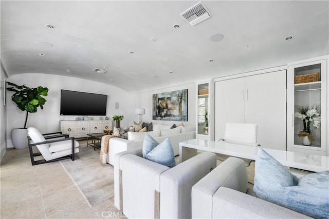 living area featuring lofted ceiling, visible vents, and recessed lighting