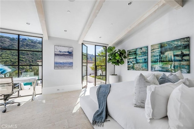 bedroom featuring stone finish floor, beam ceiling, and baseboards