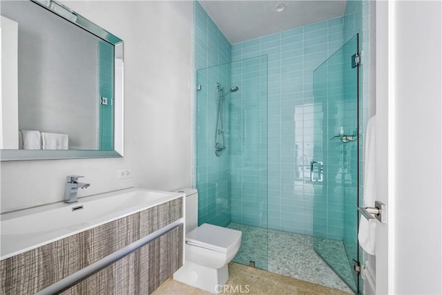 bathroom with a stall shower and toilet