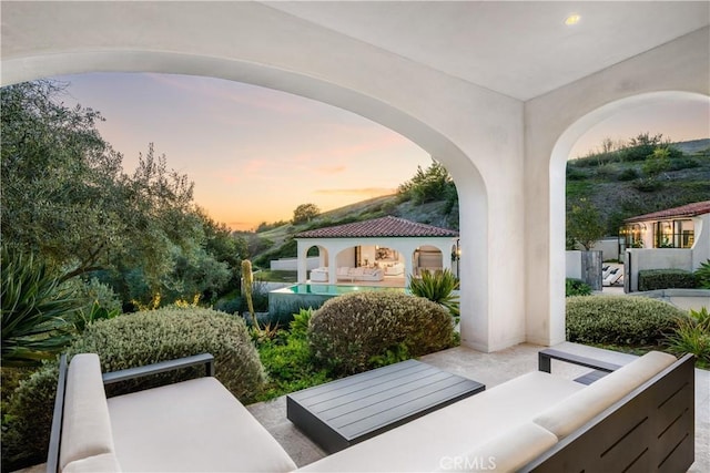 patio terrace at dusk with outdoor lounge area