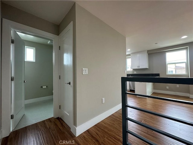 kitchen featuring dark countertops, dark wood-style floors, recessed lighting, white cabinets, and baseboards