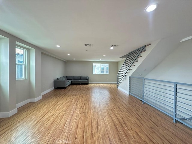 unfurnished room featuring light wood-style flooring, recessed lighting, baseboards, and visible vents