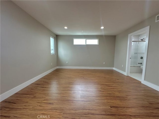 spare room with visible vents, recessed lighting, wood finished floors, and baseboards