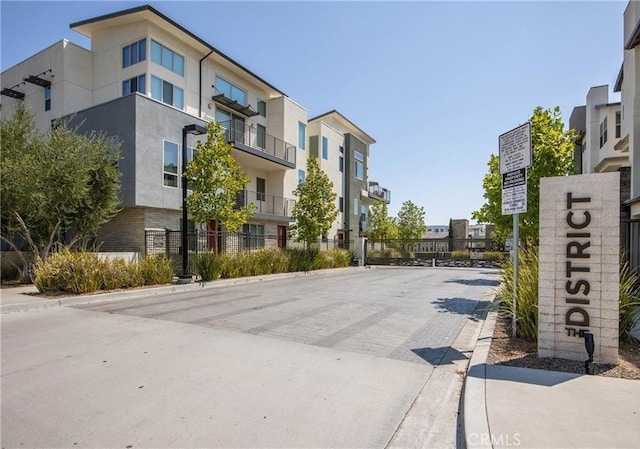 view of road featuring a residential view and curbs