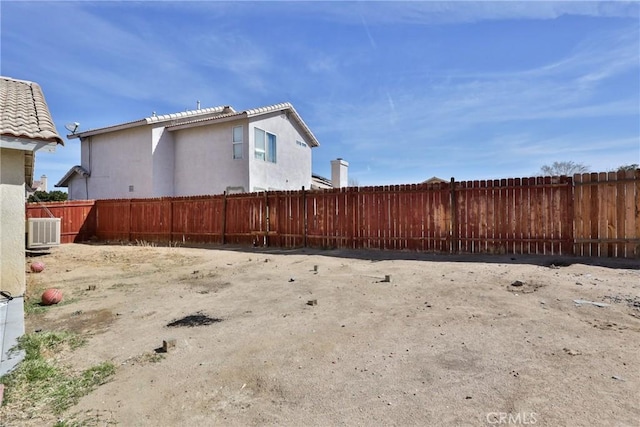 view of yard with fence and cooling unit