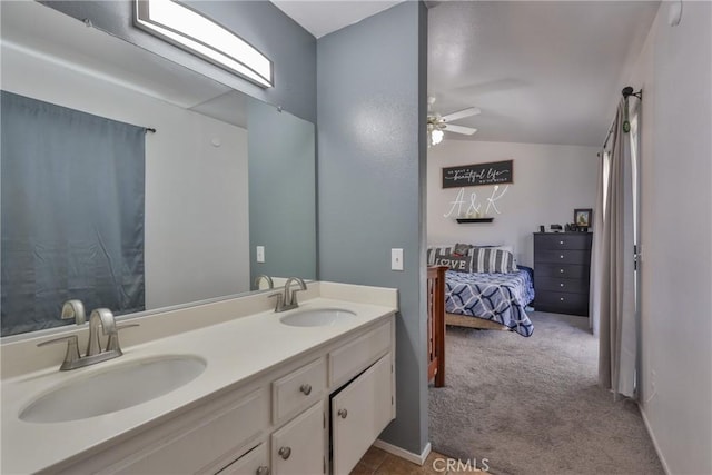 bathroom featuring vaulted ceiling, double vanity, a sink, and a ceiling fan