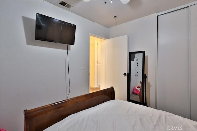 bedroom with a ceiling fan, a closet, and visible vents