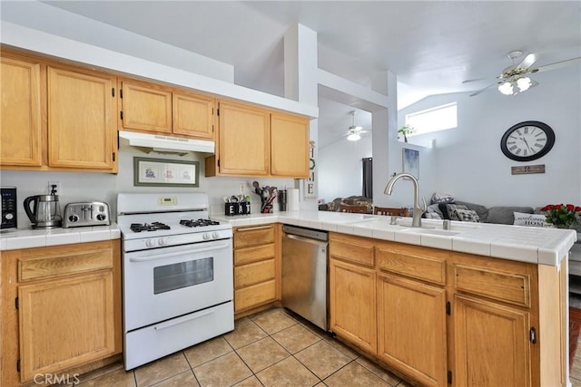 kitchen with white gas stove, a sink, ceiling fan, dishwasher, and a peninsula