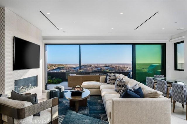 living room featuring recessed lighting and a premium fireplace