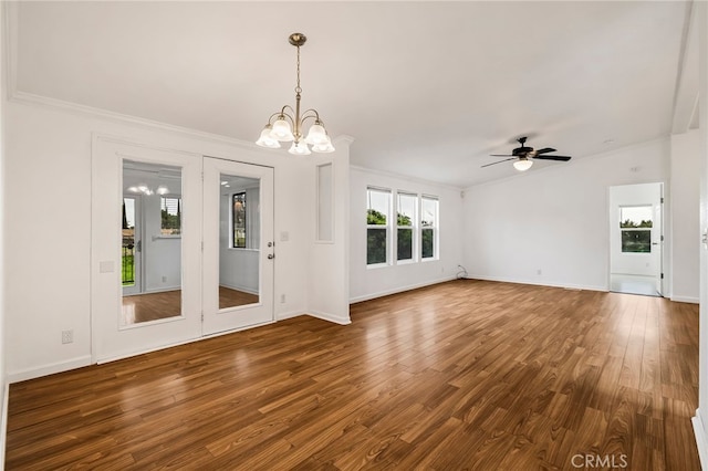 interior space with ceiling fan with notable chandelier, crown molding, baseboards, and dark wood finished floors
