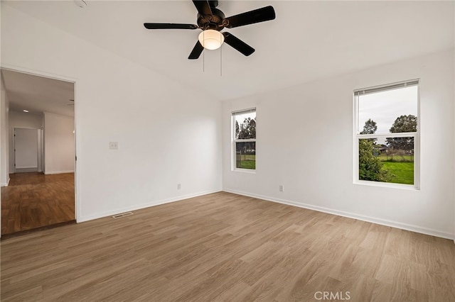 spare room with visible vents, baseboards, light wood-style floors, and ceiling fan