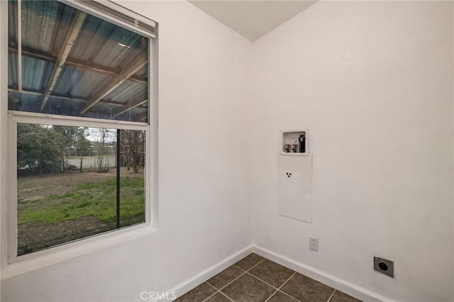 laundry room featuring hookup for a washing machine, dark tile patterned floors, baseboards, laundry area, and hookup for an electric dryer