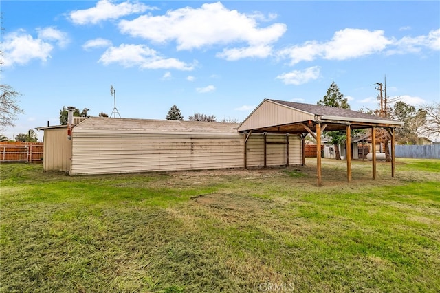 view of yard with an outbuilding and fence