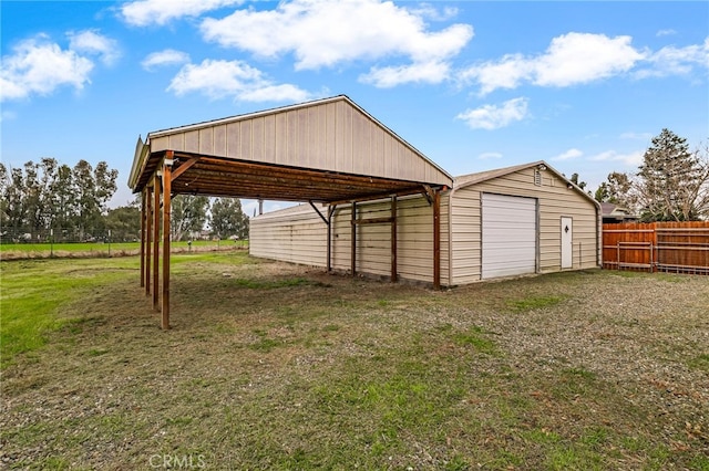 exterior space featuring fence and a detached garage