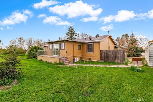 rear view of property featuring crawl space, a wooden deck, fence, and a yard