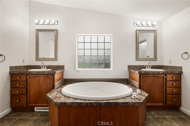bathroom with tile patterned flooring, a sink, two vanities, and visible vents