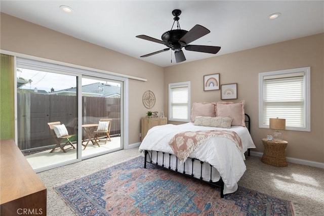 bedroom featuring multiple windows, carpet, and access to outside