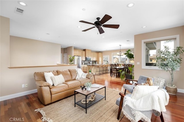 living room featuring recessed lighting, light wood-type flooring, and baseboards