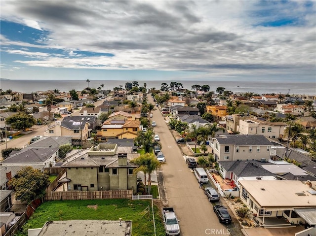 drone / aerial view featuring a residential view and a water view