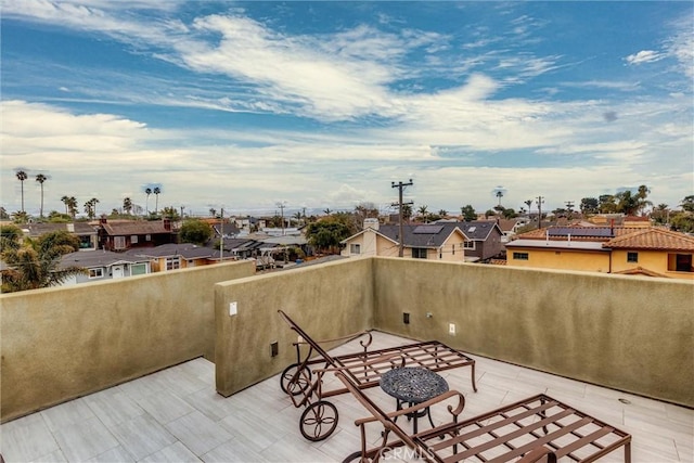 view of patio featuring a residential view and a balcony