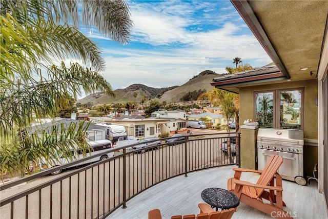 balcony with area for grilling, a mountain view, and a residential view