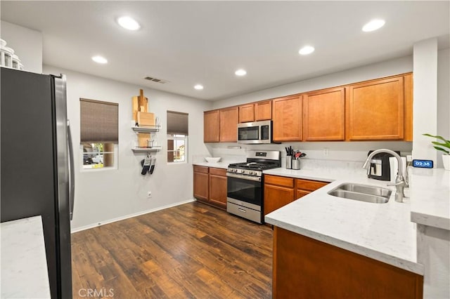 kitchen featuring recessed lighting, dark wood-type flooring, a sink, visible vents, and appliances with stainless steel finishes