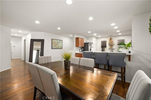 dining space featuring baseboards, dark wood-style flooring, and recessed lighting