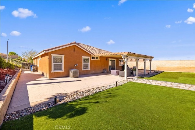 back of property featuring a patio, stucco siding, a lawn, a pergola, and a fenced backyard