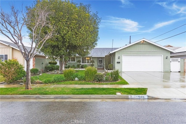 single story home featuring concrete driveway and a garage