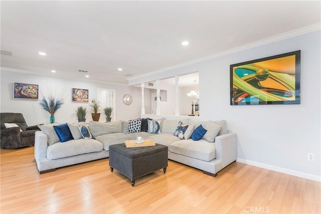 living area with a notable chandelier, ornamental molding, wood finished floors, recessed lighting, and baseboards