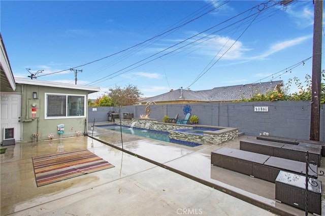 view of pool with a fenced in pool, an in ground hot tub, a fenced backyard, and a patio area