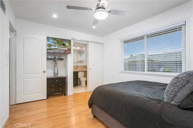 bedroom featuring ceiling fan, recessed lighting, light wood finished floors, and connected bathroom