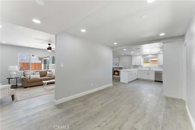 living room with light wood finished floors, a wealth of natural light, and recessed lighting