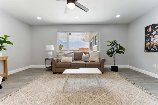 living room with a ceiling fan, recessed lighting, baseboards, and wood finished floors