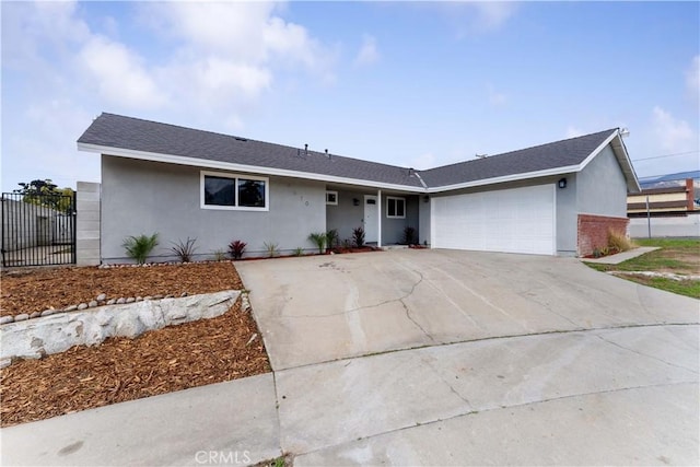 single story home featuring a garage, driveway, fence, and stucco siding