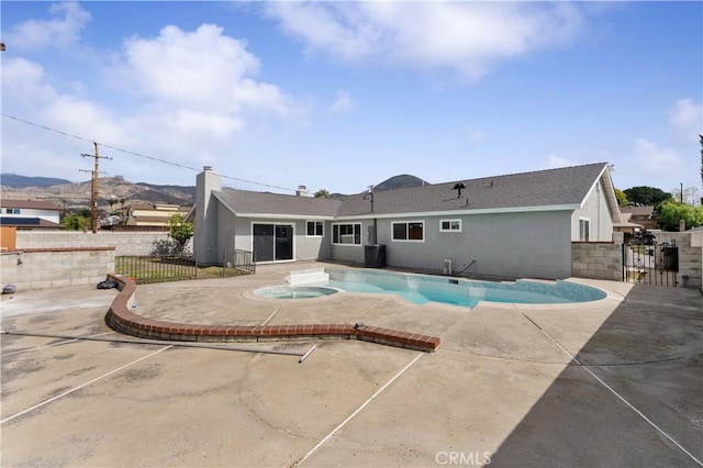 view of pool featuring a fenced in pool, a patio area, fence, and an in ground hot tub