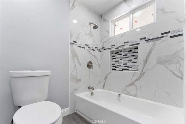 full bathroom featuring toilet, washtub / shower combination, baseboards, and wood finished floors