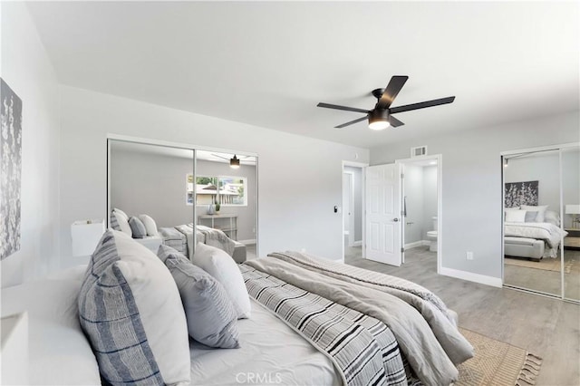 bedroom with a closet, visible vents, ceiling fan, wood finished floors, and baseboards