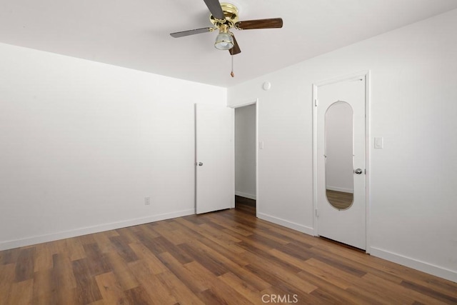 unfurnished bedroom featuring a ceiling fan, baseboards, and wood finished floors