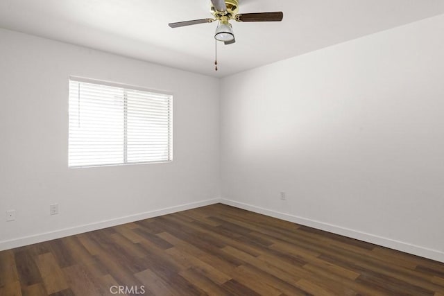 empty room featuring ceiling fan, baseboards, and dark wood-style flooring