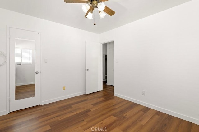 unfurnished bedroom with ceiling fan, wood finished floors, and baseboards