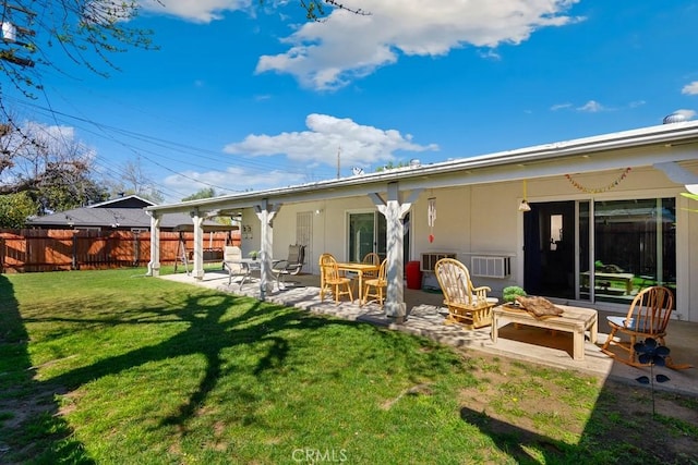 back of house featuring a yard, an outdoor fire pit, a patio, and fence