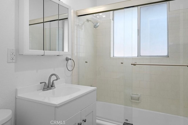 full bath with  shower combination, vanity, and toilet