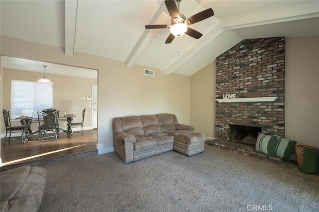 living room featuring visible vents, lofted ceiling with beams, ceiling fan, carpet, and a brick fireplace