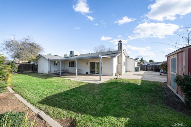 back of house featuring a patio area, a fenced backyard, a lawn, and stucco siding