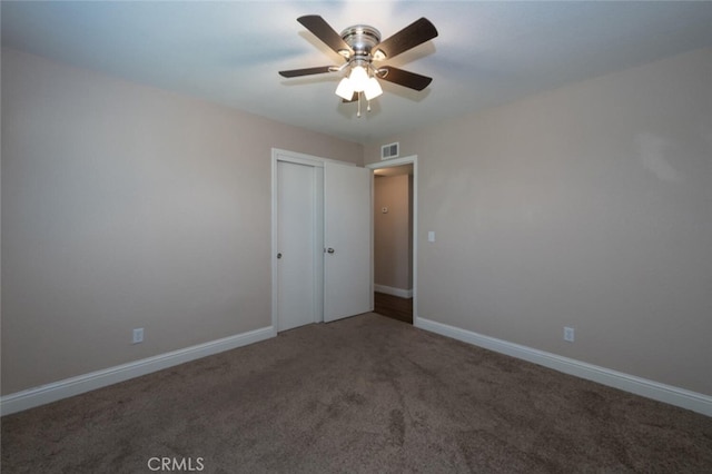 unfurnished bedroom featuring carpet floors, a closet, and baseboards