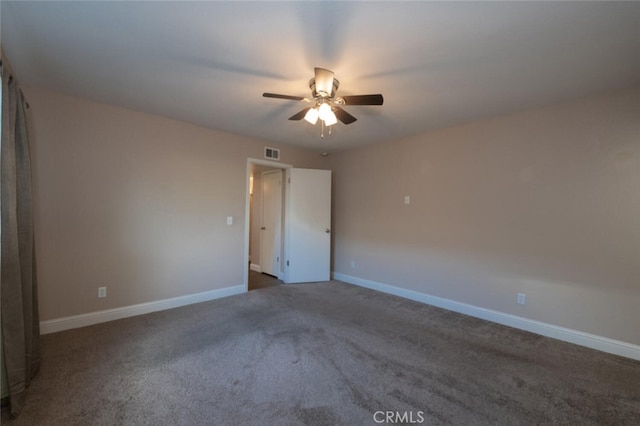 unfurnished room with a ceiling fan, carpet flooring, visible vents, and baseboards