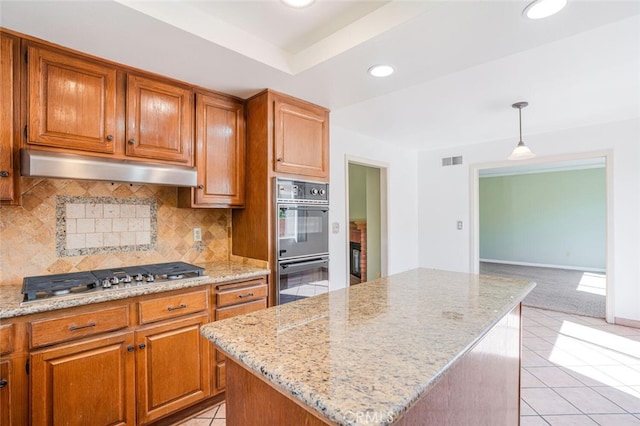 kitchen featuring visible vents, stainless steel gas stovetop, backsplash, dobule oven black, and under cabinet range hood