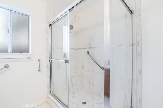 full bathroom with a marble finish shower