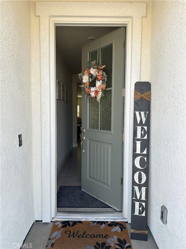 entrance to property with stucco siding